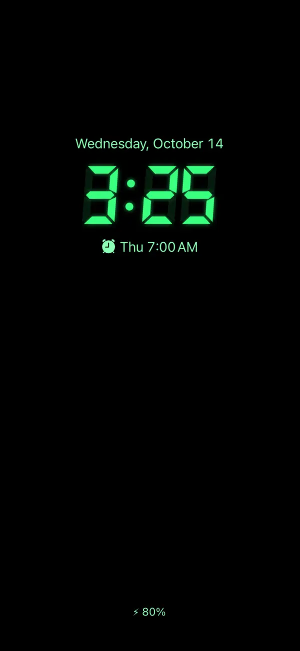 The always-on display with a green segment clock on black, the next alarm below it